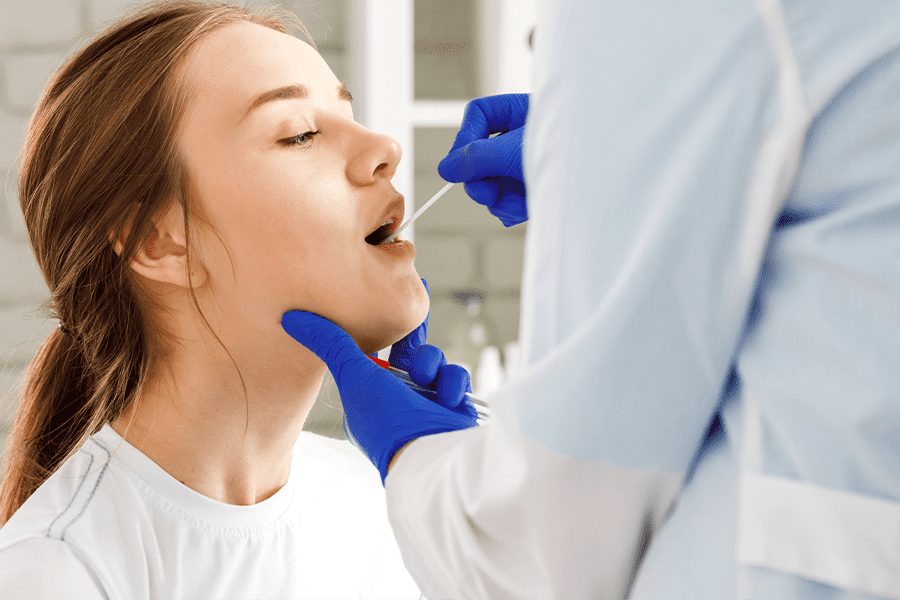 patient getting mouth swabbed for std test